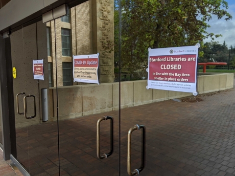 closed signs at the entrance of green library