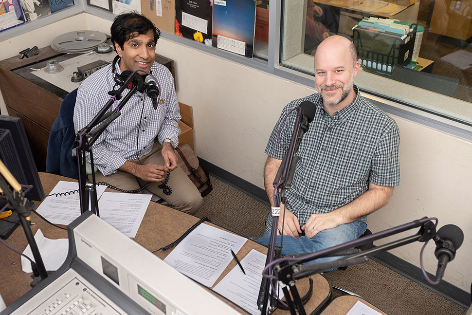 Ameet Doshi (right), director of innovation and program design and subject librarian at Georgia Tech’s (GT) School of Public Policy and Law, and Charlie Bennett, public engagement librarian and subject librarian for GT’s School of Economics, in GT’s campus radio station. (Photo: Allison Carter/Georgia Institute of Technology)