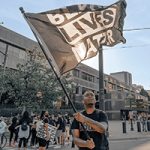 Protester holding Black Lives Matter flag
