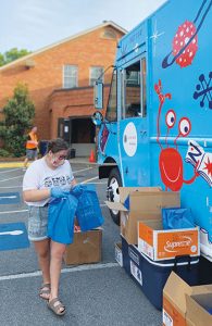 Reading to Go Places volunteer Madison Cowart distributes books and meals at a stop in Bartow County, Georgia, in April 2020. <span class="credit"></noscript>Photo: Reading to Go Places</span>” width=”195″ height=”300″ srcset=”https://temilib.nasniconsultants.com/wp-content/uploads/2021/03/the-road-to-normal-3.jpg 195w, https://temilib.nasniconsultants.com/wp-content/uploads/2021/03/the-road-to-normal-8.jpg 350w” sizes=”(max-width: 195px) 100vw, 195px”><figcaption id=