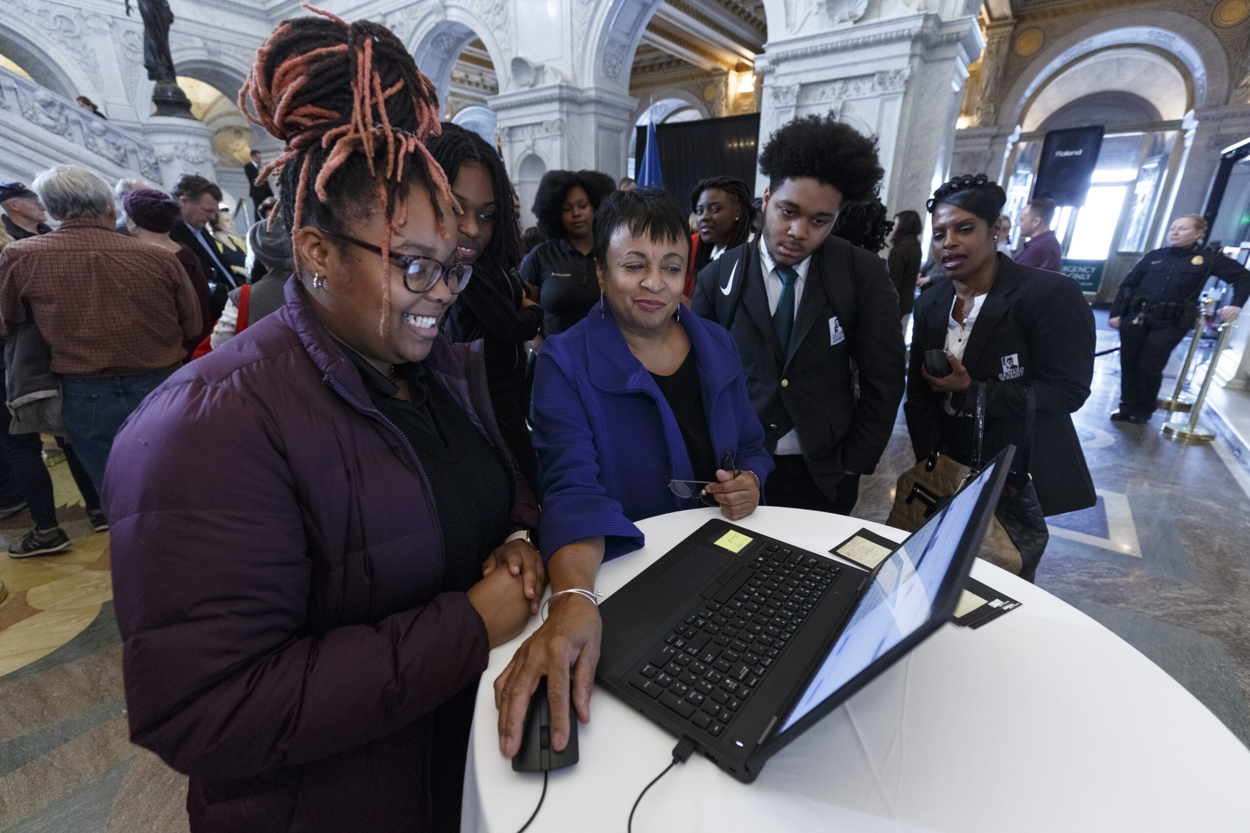 A group of students gather around the Librarian of Congress, Dr. Carla Hayden, to help transcribe document for By the People during an event in 2018. Photo by Shawn Miller.