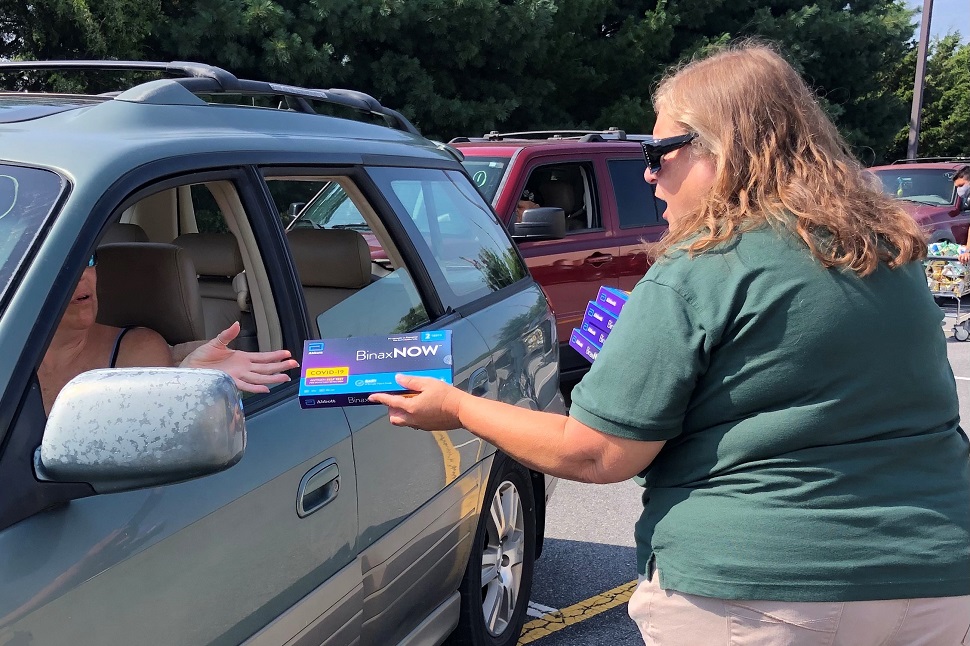 Kathy McFadden (right), a staffer at Sussex County (Del.) Libraries, hands out rapid, at-home COVID-19 testing kits during a drive-through distribution event at Seaford (Del.) District Library in August 2021. Photo: Delaware Division of Libraries