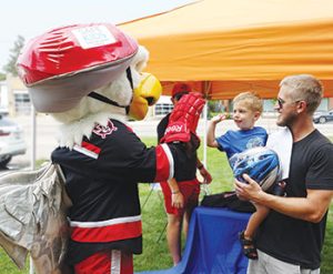 Griff—mascot for the Grand Rapids Griffins, a pro hockey team—greets fans at Grand Rapids (Mich.) Public Library’s Lids at the Library helmet giveaway in summer 2021. Photo by Katie Zychowski/Grand Rapids (Mich.) Public Library.