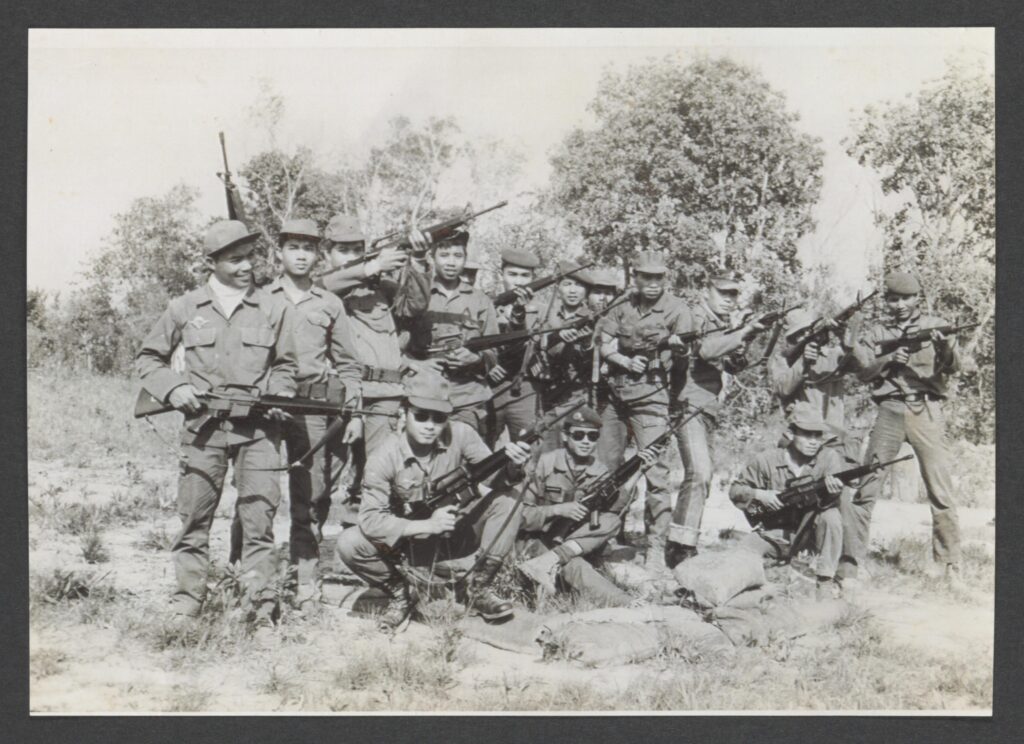 Black and white image of an armed group training in Laos and Thailand